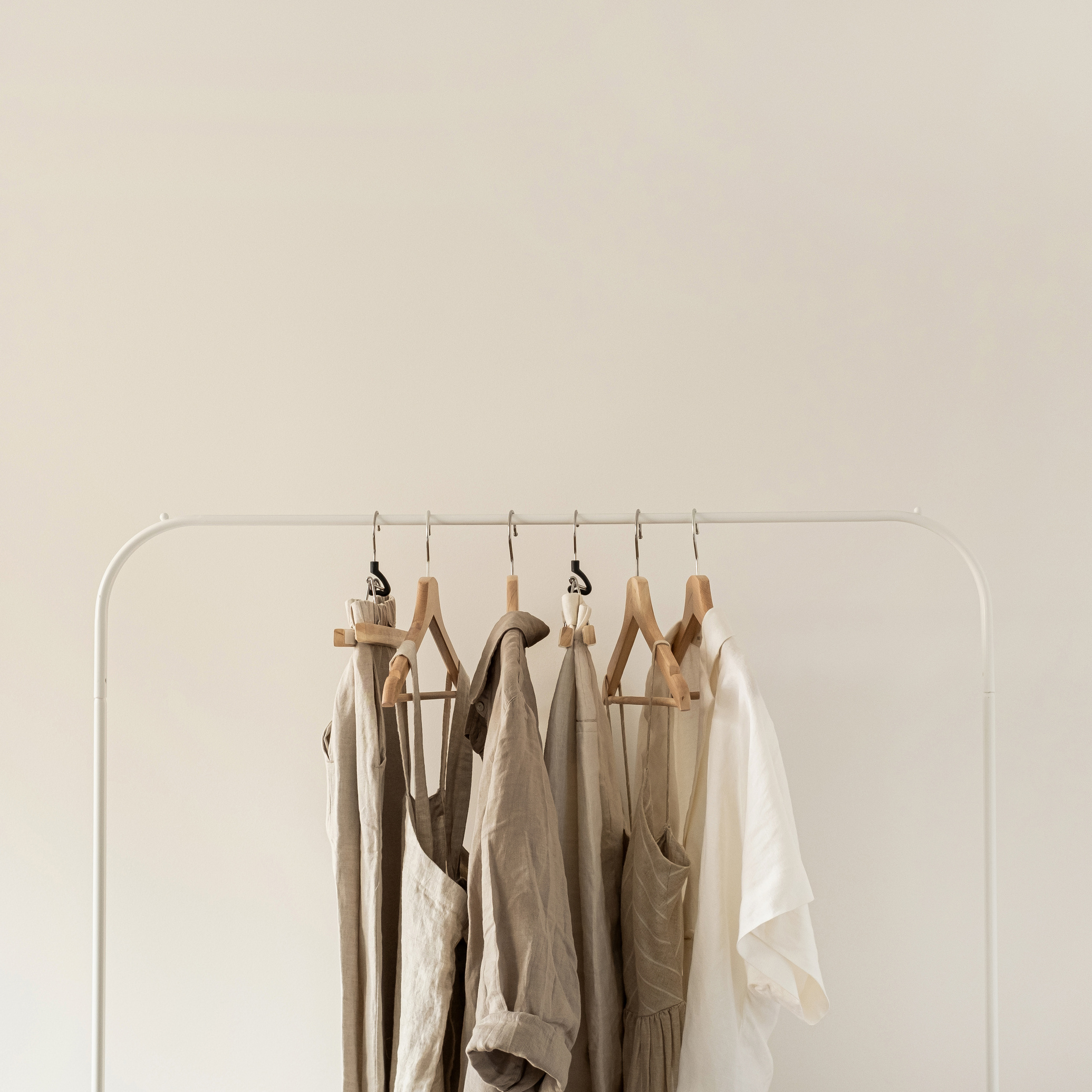 Neutral Clothes Hanging on Clothes Rack 